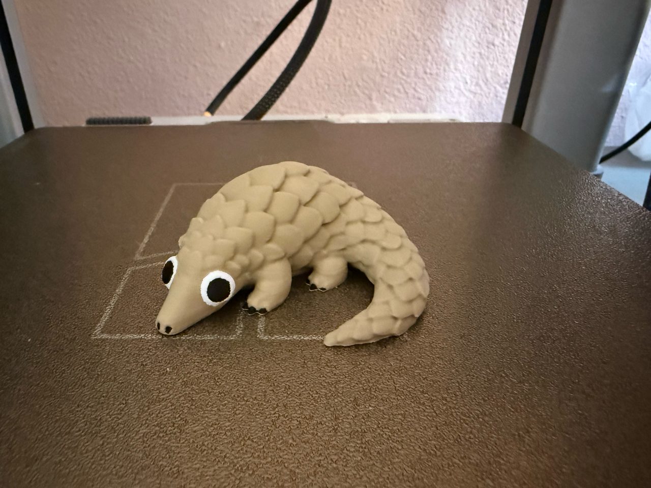 A printed pangolin, scales resolved, on the build plate